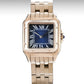 Rose gold watch with blue face on a white background