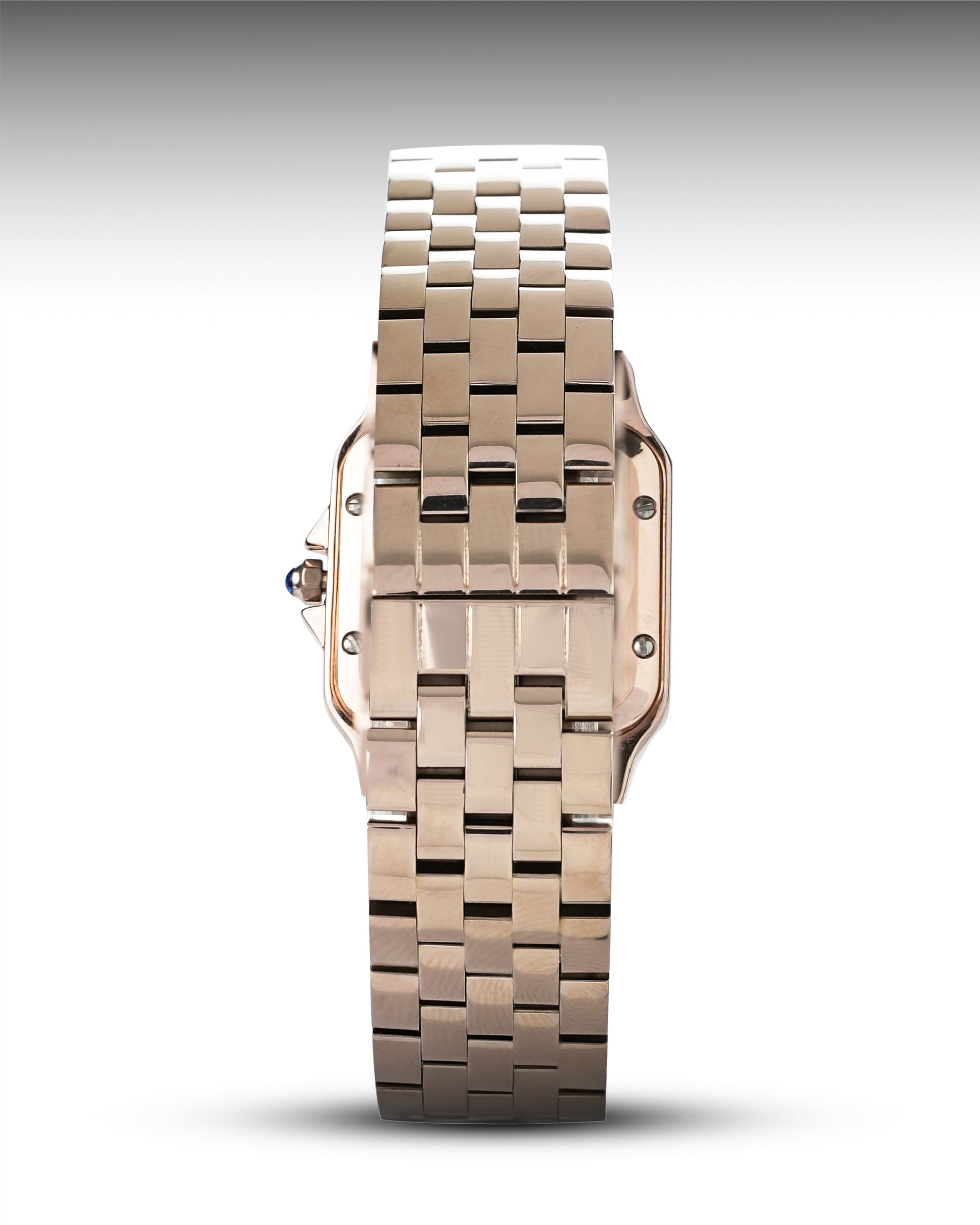Rose gold watch with a metallic band on a white background