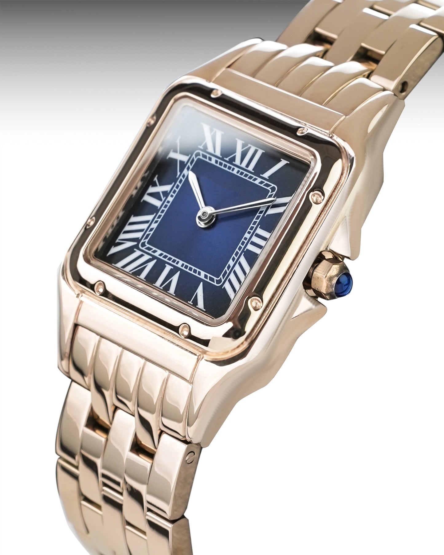 Rose gold watch with blue face and gemstone on a white background