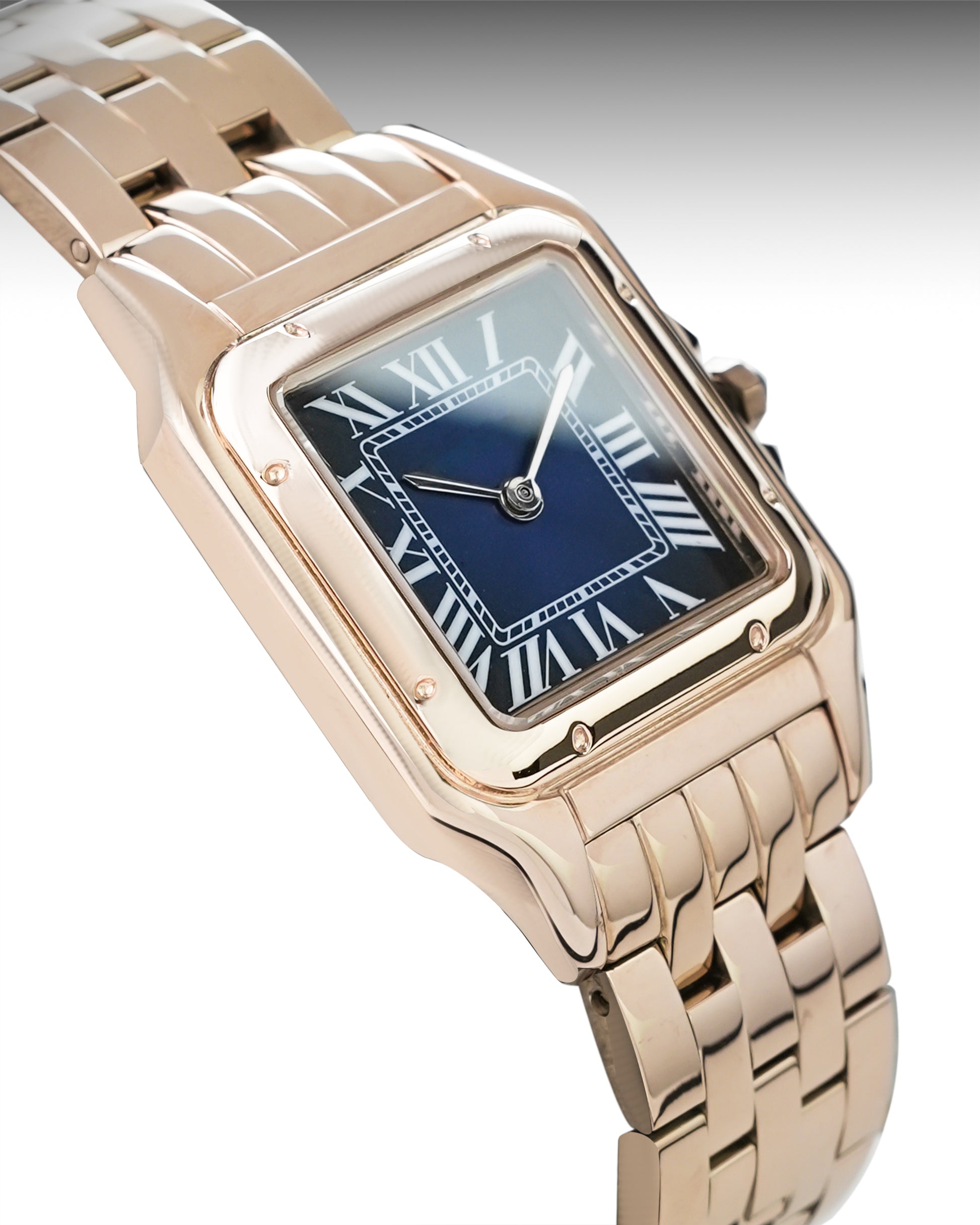 Rose gold watch with a blue face on a gray background