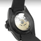 Close-up of a black watch with mechanical components visible