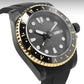 Black and gold watch with detailed face on a white background